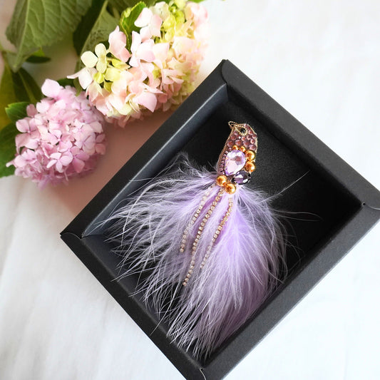 Handmade beaded bird brooch small size with lilac purple and gold beads, gemstones and feathers in a box