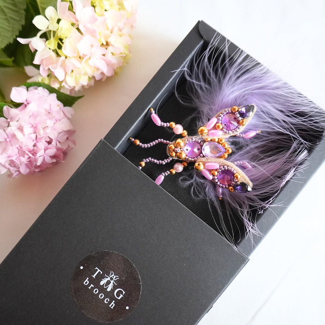 Handmade beaded TGbrooch small size with purple and gold beads, gemstones and feathers