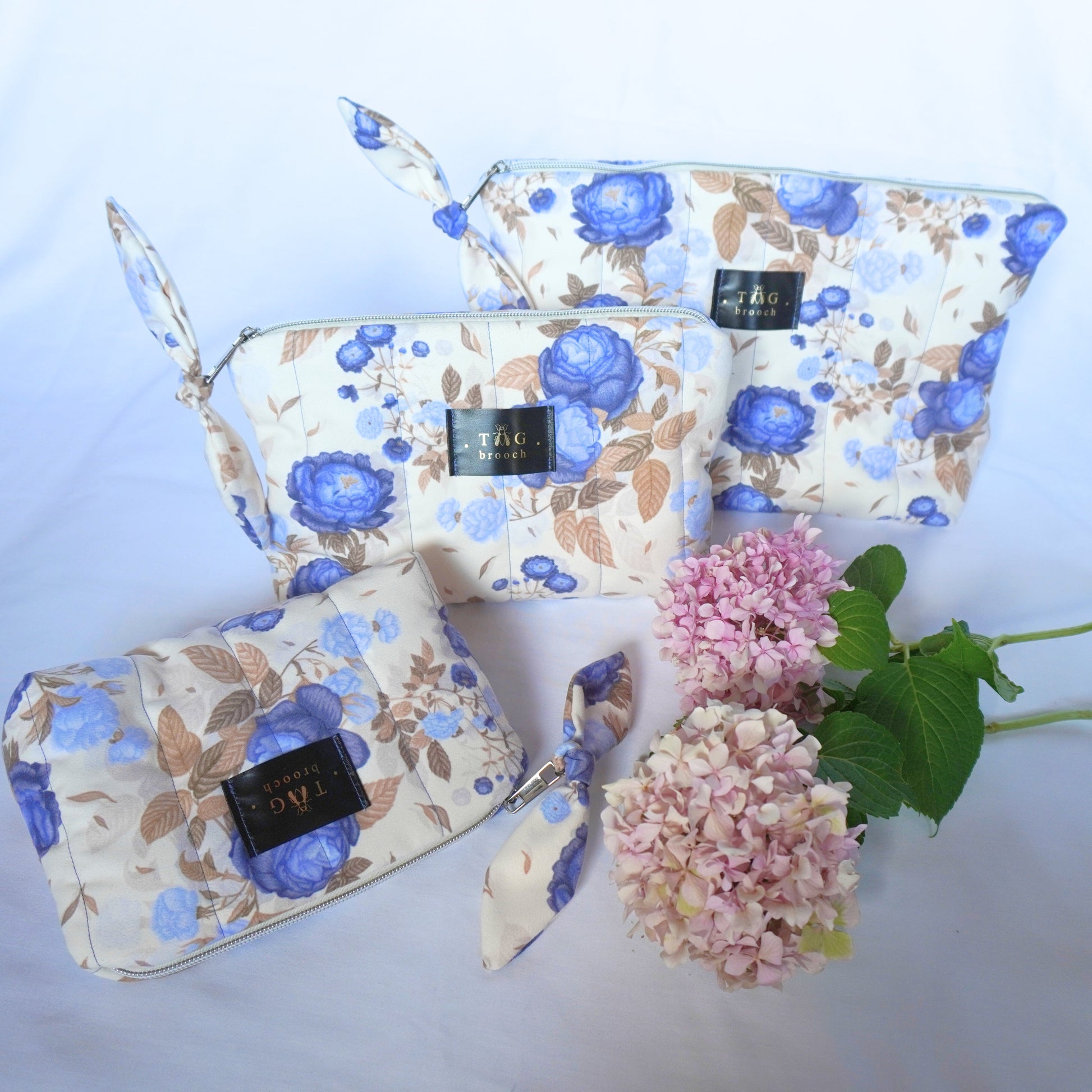 Set of handmade quilted toilerty bags with floral blue roses pattern print designed by TGbrooch